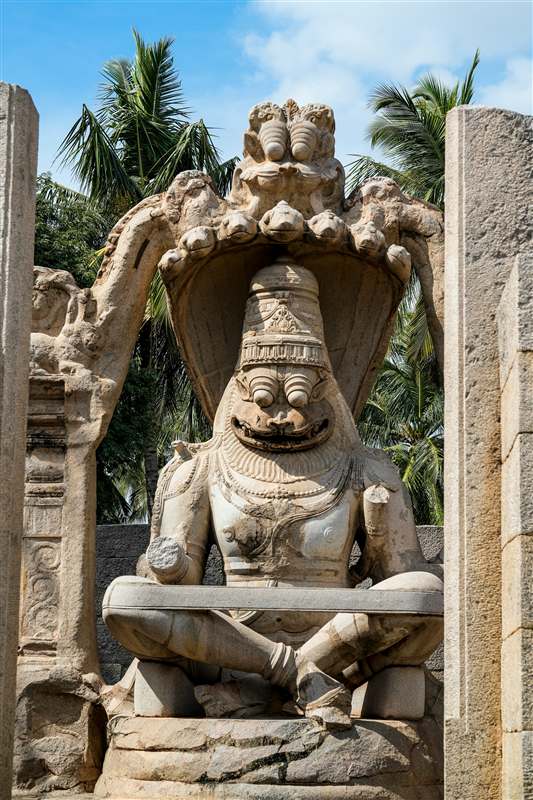 Carved stone figure in a temple niche in Karnataka
